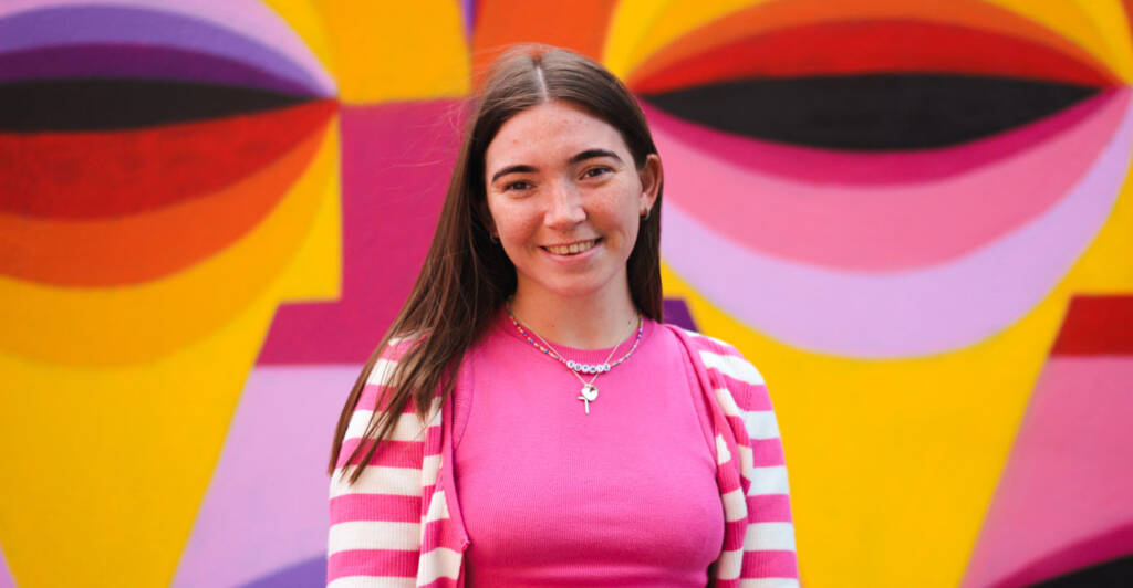 Photo of Sophie with a colourful graffiti background
