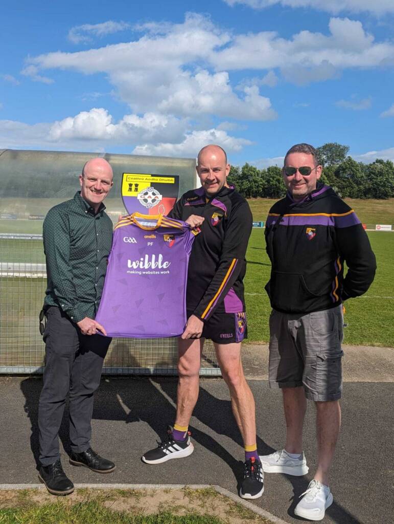 presentation of the Wibble sponsored jersey by Paudie Fearon of Wibble to the Dads & Lads representative, Ryan McCauley, along with Brendan Sloan – Chairperson of Carryduff G.A.C.